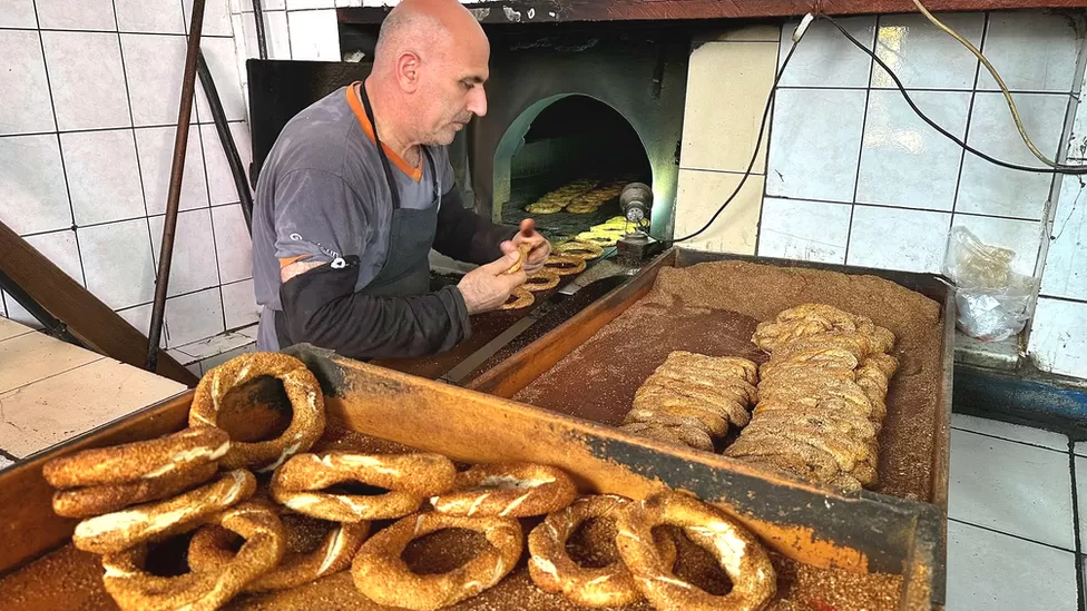 Burhan Morkoc says it's becoming more and more expensive to produce the bagel-like pastries he bakes in Istanbul