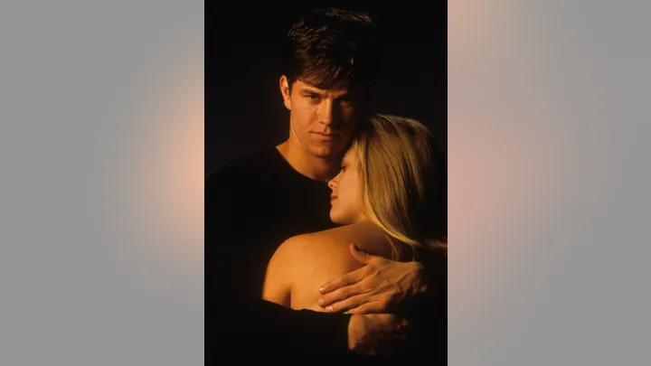 Mark Wahlberg holds Witherspoon in a publicity portrait for the film Fear.