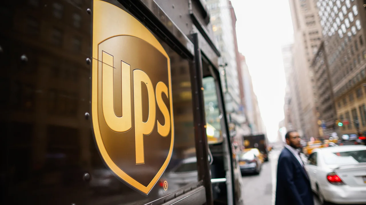 UPS says its profit will fall after it reaches a Teamsters deal.