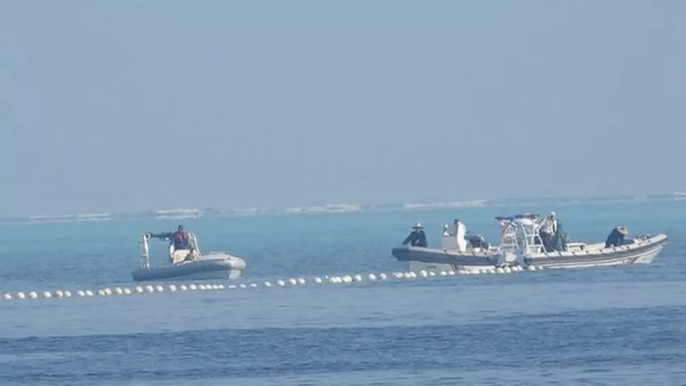 Philippines says Beijing installed floating barrier in contested area