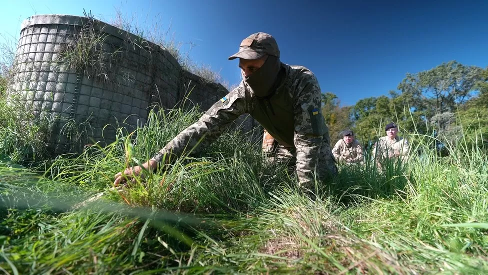 Training to clear the world’s most heavily mined country