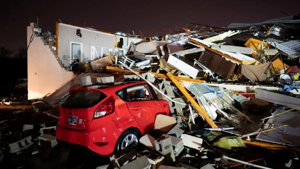 At least six dead as tornadoes rip through state.